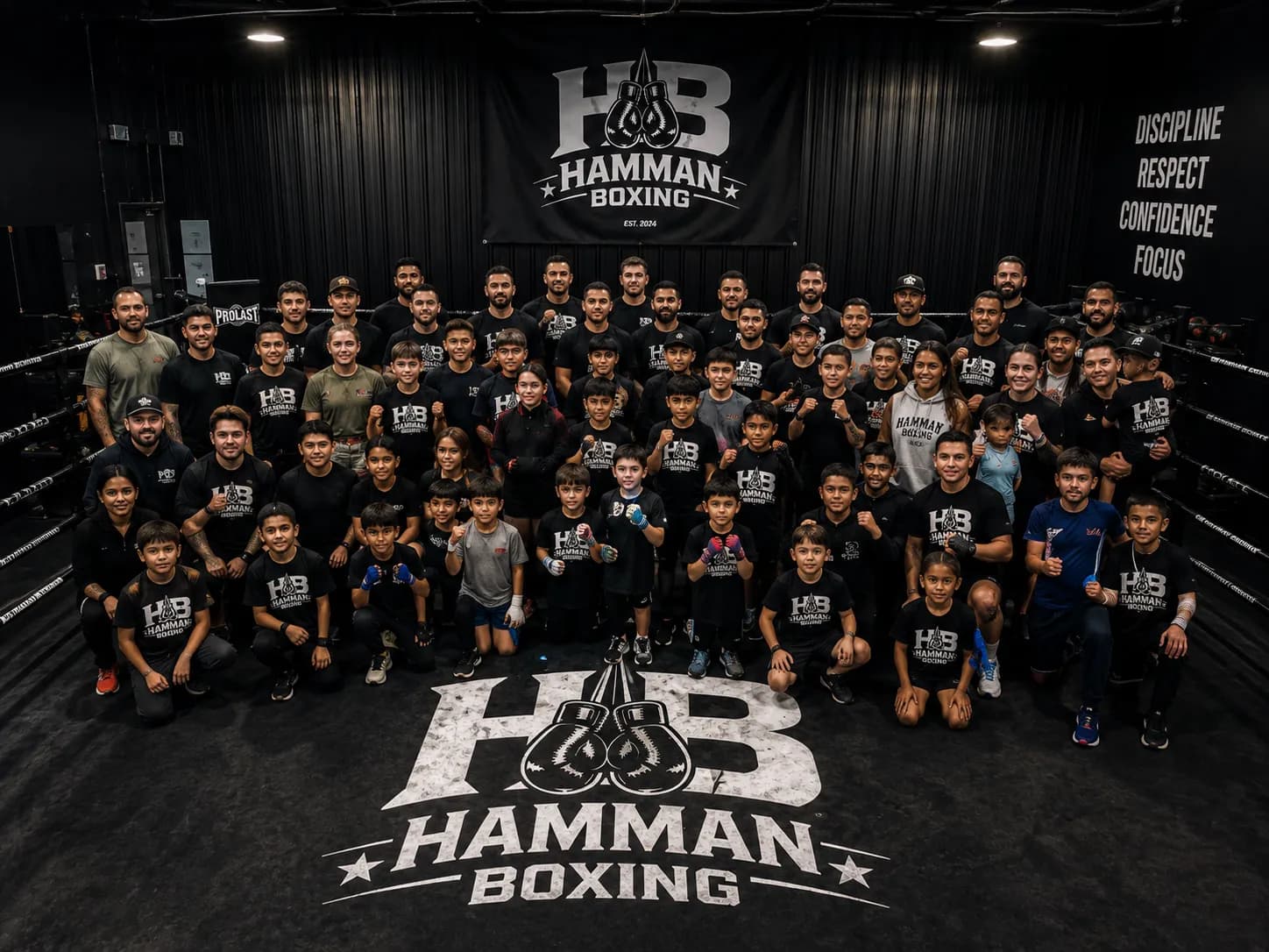 Members, coaches and families gathered in the ring at Hamman Boxing