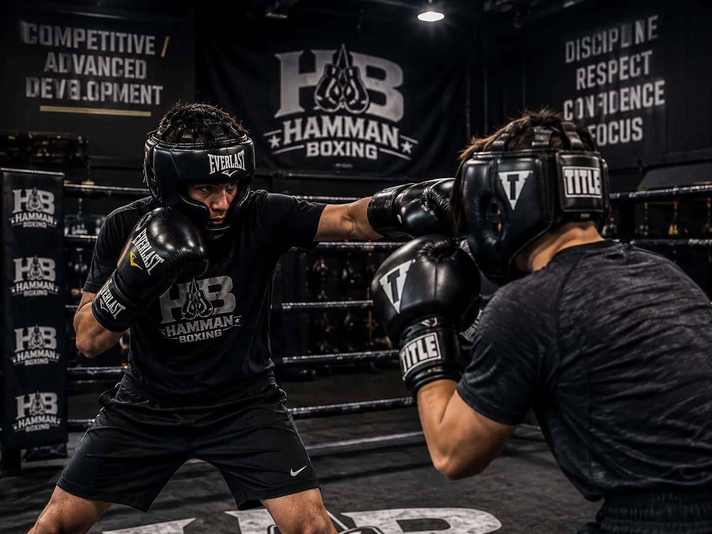Two boxers in headgear sparring in the ring during advanced development training